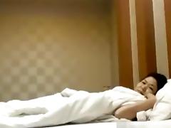 Asian girl gets missionary fucked on the bed and moans