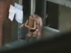 Voyeur captures the neighbors having sex on the balcony