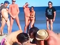 Amateur swingers on the nudist beach having groupsex
