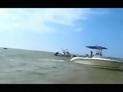 Crazy girl sucks cock on a boat, while other people can see it and spreads her ass in the salty sea.