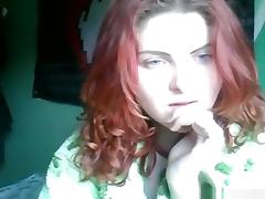 Redheaded girl rubs one off on her bed