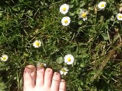 Walking on the grass and daisies showing my feet