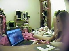 Asian girl watches porn and rubs pussy