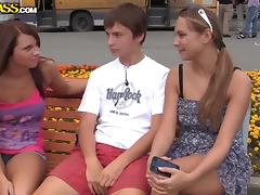 Two adorable chicks pleasing a guy in the park
