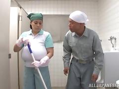 Mature Asian lets a guy play with her enormous boobs in a WC
